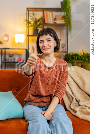 Excited Caucasian woman looking approvingly at camera showing thumbs up, like sign positive feedback Excited Caucasian woman looking approvingly at camera showing thumbs up, like sign positive feedback 117369821