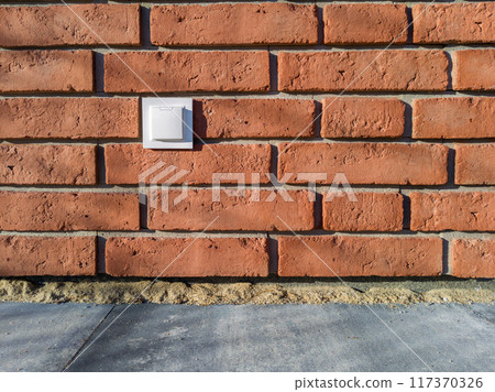Outdoor Electrical Socket on Red Brick Wall Outdoor Electrical Socket on Red Brick Wall 117370326