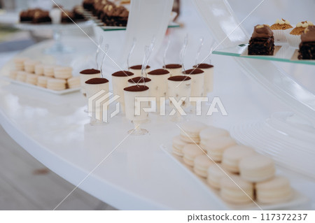 Set of delicious sweet cakes and dessert in the restaurant. Scene is celebratory and festive Set of delicious sweet cakes and dessert in the restaurant. Scene is celebratory and festive 117372237