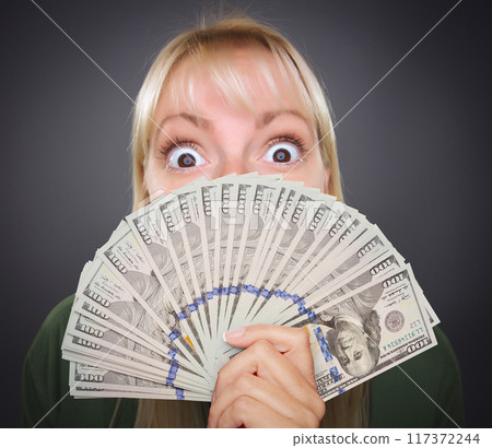 Girl Holding Thousands of Dollars in One Hundred Dollar Bills Fanned Out In Her Hand. Girl Holding Thousands of Dollars in One Hundred Dollar Bills Fanned Out In Her Hand. 117372244