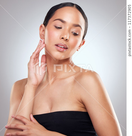 Strong woman are made of grit and grace. Studio shot of a beautiful young woman posing against a grey background. 117372905