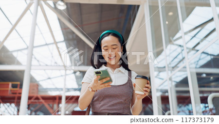 Office, phone and coffee of business woman from Japan with online communication. Smartphone, typing and happy Asian person walking with a smile and texting for networking or social media at work 117373179