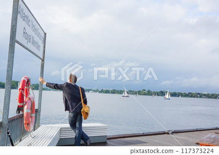 Man looking at an open lake Man looking at an open lake 117373224
