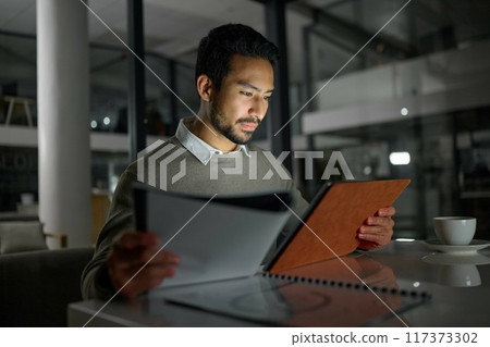 Businessman, tablet and analytics working at night for planning, documents or online research at office. Male employee with touchscreen in analysis, strategy or project plan for evening at workplace 117373302