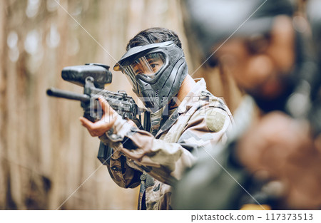 Paintball, gun and target with man, sports and action outdoor, battlefield and soldier, focus during war game. Extreme sport, aim weapon and military mission, exercise and fitness with team 117373513
