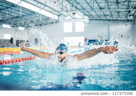 Man, breathing or butterfly stroke in swimming pool cap for sports wellness, training or exercise for body healthcare. Workout, fitness and swimmer athlete in motion for water competition challenge 117373560