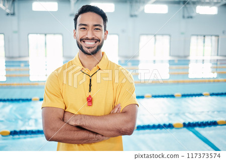 Portrait, proud and coach at a swimming pool for training, exercise and practice at indoor center. Face, happy and personal trainer ready for teaching, swim and athletic guidance, smile and excited 117373574