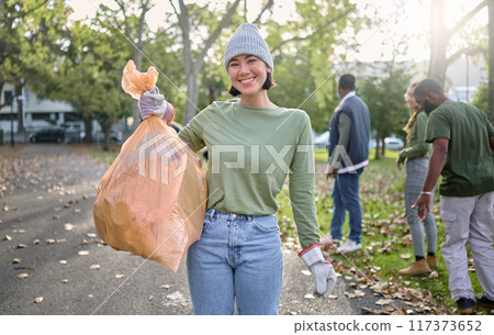 Plastic bag, park and happy woman in cleaning portrait for earth day, community service or volunteering support. Recycle, trash or garbage goals of ngo person helping in nature or forest pollution 117373652