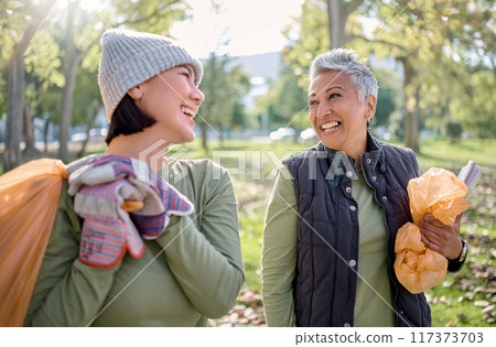 Cleaning, plastic bag and people in park for community service, volunteering and pollution help, support and goals. Happy senior woman with youth in nature or forest with waste, garbage or recycling Cleaning, plastic bag and people in park for community service, volunteering and pollution help, support and goals. Happy senior woman with youth in nature or forest with waste, garbage or recycling 117373703