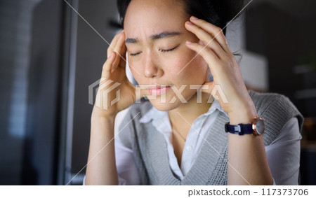 Stress, headache and woman with burnout, anxiety and problems with mental health at night. Tired, pain and asian girl suffering from insomnia, stressed and pressure, unhappy and frustrated Stress, headache and woman with burnout, anxiety and problems with mental health at night. Tired, pain and asian girl suffering from insomnia, stressed and pressure, unhappy and frustrated 117373706
