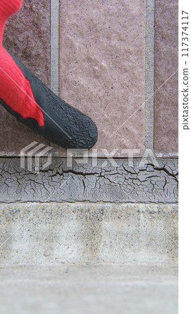 Worker inspecting exterior wall | Deterioration of joints, close-up shot Worker inspecting exterior wall | Deterioration of joints, close-up shot 117374117