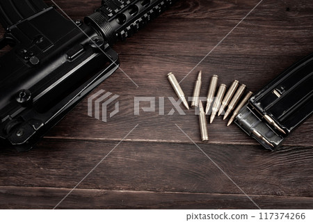 Rifle and Ammunition with magazine on wooden table Rifle and Ammunition with magazine on wooden table 117374266