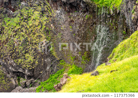 The delicate Furepe Falls (Maiden's Tears) cascades down a cliff into the Sea of Okhotsk. 117375366