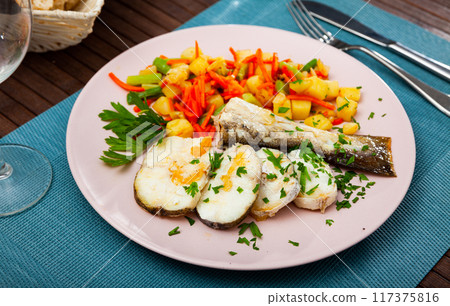 Sliced fried codfish served with potatoes and carrots Sliced fried codfish served with potatoes and carrots 117375816