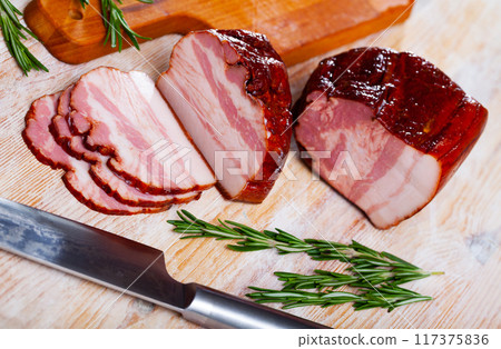 Sliced smoked bacon on wooden table 117375836