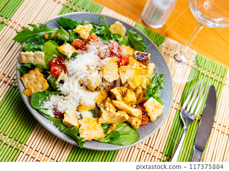 Caesar salad with chicken and parmesan cheese 117375884