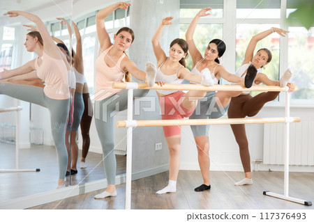 Ballet pose grand batman - young ballerinas at choreography lesson 117376493