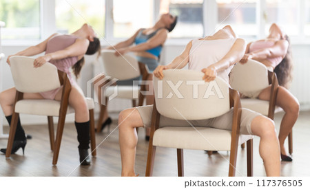 Sitting on chair, girl train to perform lap dance, interacting with imaginary partner Sitting on chair, girl train to perform lap dance, interacting with imaginary partner 117376505
