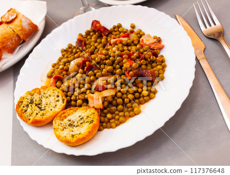 Plate of stewed beans with ham on table Plate of stewed beans with ham on table 117376648