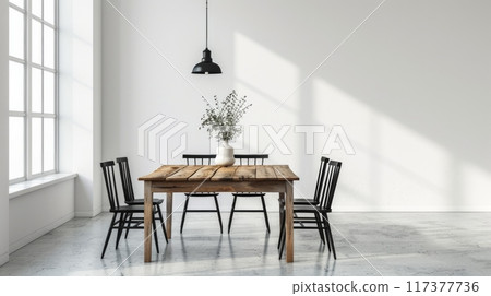 minimalist dining area with a wooden table, black metal chairs, and a single pendant light, set against a backdrop of concrete floors and white walls 117377736