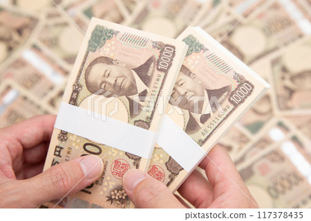 A man's hand holding a stack of bills A man's hand holding a stack of bills 117378435