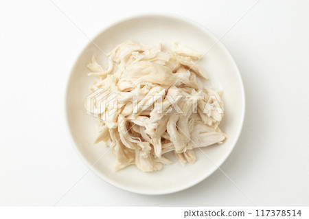 Boiled and split chicken breast on white background 117378514