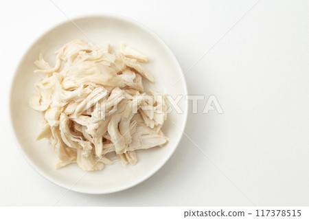 Boiled and split chicken breast on white background 117378515