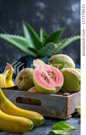 A rustic arrangement of fresh guavas and bananas in a wooden crate, showcasing the vibrant colors and natural textures of tropical fruits.. A rustic arrangement of fresh guavas and bananas in a wooden crate, showcasing the vibrant colors and natural textures of tropical fruits.. 117379015