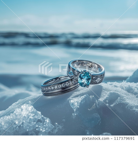 Elegant aquamarine engagement ring paired with a detailed band, showcased on a piece of ice against a blurry ocean backdrop.. Elegant aquamarine engagement ring paired with a detailed band, showcased on a piece of ice against a blurry ocean backdrop.. 117379691