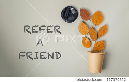 a brown cup with the words refer a friend written below it 117379832