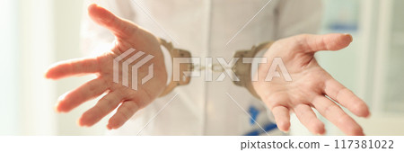 Doctor with stethoscope in handcuffs. Nurse with metal handcuffs on hands 117381022