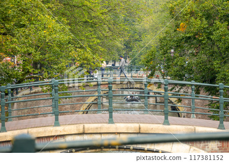 Amsterdam Canal Bridges Surrounded by Green Trees 117381152