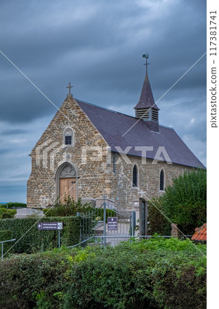 The historical stone church stands out dramatically under a picturesque sky with scenic clouds 117381741