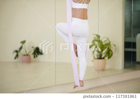 Practicing Aerial Yoga Poses with Grace and Balance 117381861