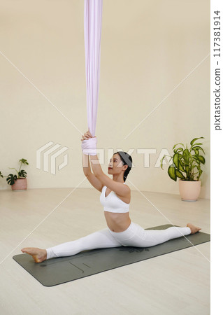 Performing Yoga Stretching on Eco-Friendly Mat 117381914