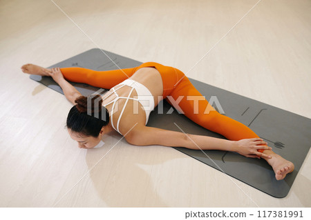 Practicing Yoga on Mat with Stretch and Balance 117381991