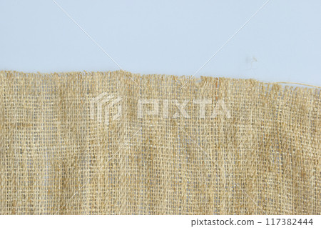 torn sackcloth isolated on white background, burlap fabric texture for design torn sackcloth isolated on white background, burlap fabric texture for design 117382444