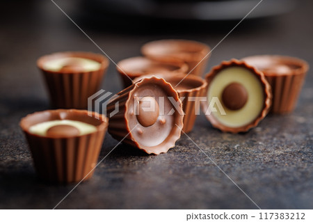 Sweet pralines. Chocolate truffles on black table. 117383212
