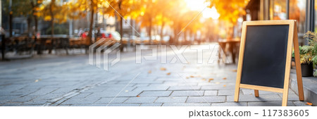 A wooden chalkboard sign for exterior advertisement rests on the pavement 117383605