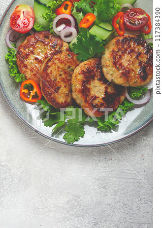 fried chicken cutlets, minced chicken, with vegetables, on gray , with vegetable salad, top view, homemade, no people, fried chicken cutlets, minced chicken, with vegetables, on gray , with vegetable salad, top view, homemade, no people, 117384390
