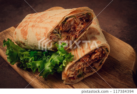 cut shawarma, 2 pieces, on a cutting board, close-up, 117384394