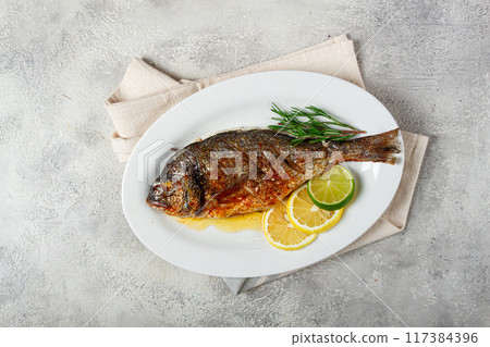 baked dorado fish, in the oven, fried dorado, with spices and herbs, on a white plate, top view, homemade, no people, baked dorado fish, in the oven, fried dorado, with spices and herbs, on a white plate, top view, homemade, no people, 117384396