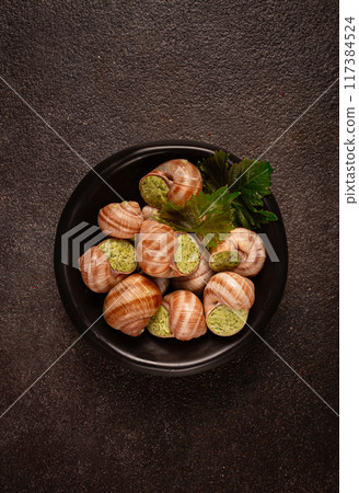 snails stuffed in Burgundy, on a black plate, with grape leaves, French cuisine, no people, snails stuffed in Burgundy, on a black plate, with grape leaves, French cuisine, no people, 117384524