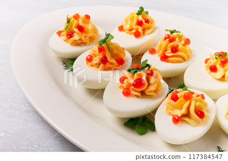 Stuffed eggs, with red caviar, micro greenery, Snack, on a white plate, top view, close-up, no people, Stuffed eggs, with red caviar, micro greenery, Snack, on a white plate, top view, close-up, no people, 117384547