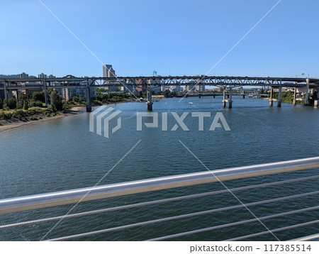 Portland, Oregon, USA - 07.11.2024 View from the Ross Island Bridge to the Marquam Bridge and the city. Portland, Oregon, USA - 07.11.2024 View from the Ross Island Bridge to the Marquam Bridge and the city. 117385514