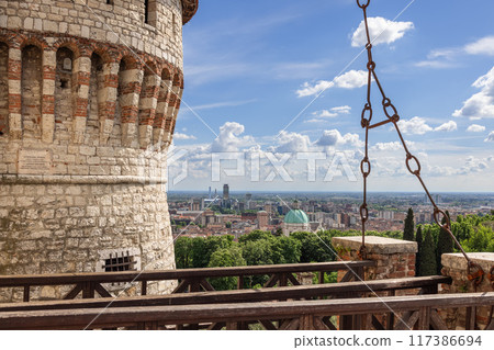 Brescia Castle drawbridge view, stone tower, Duomo dome, historic ambiance Brescia Castle drawbridge view, stone tower, Duomo dome, historic ambiance 117386694