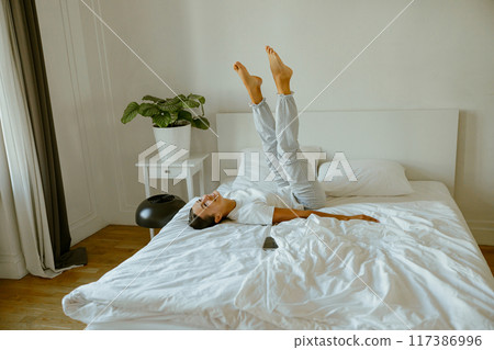 Experience a Relaxing and Refreshing Morning Routine in the Comfort of a Cozy Bedroom Space 117386996