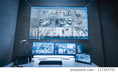 Surveillance footage displayed on computer monitors and big digital screen Surveillance footage displayed on computer monitors and big digital screen 117387782