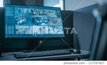Workplace for security guard with computer monitor showing surveillance footage 117387827