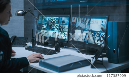 Female dispatch or CCTV operator works on computer in monitoring center 117387909